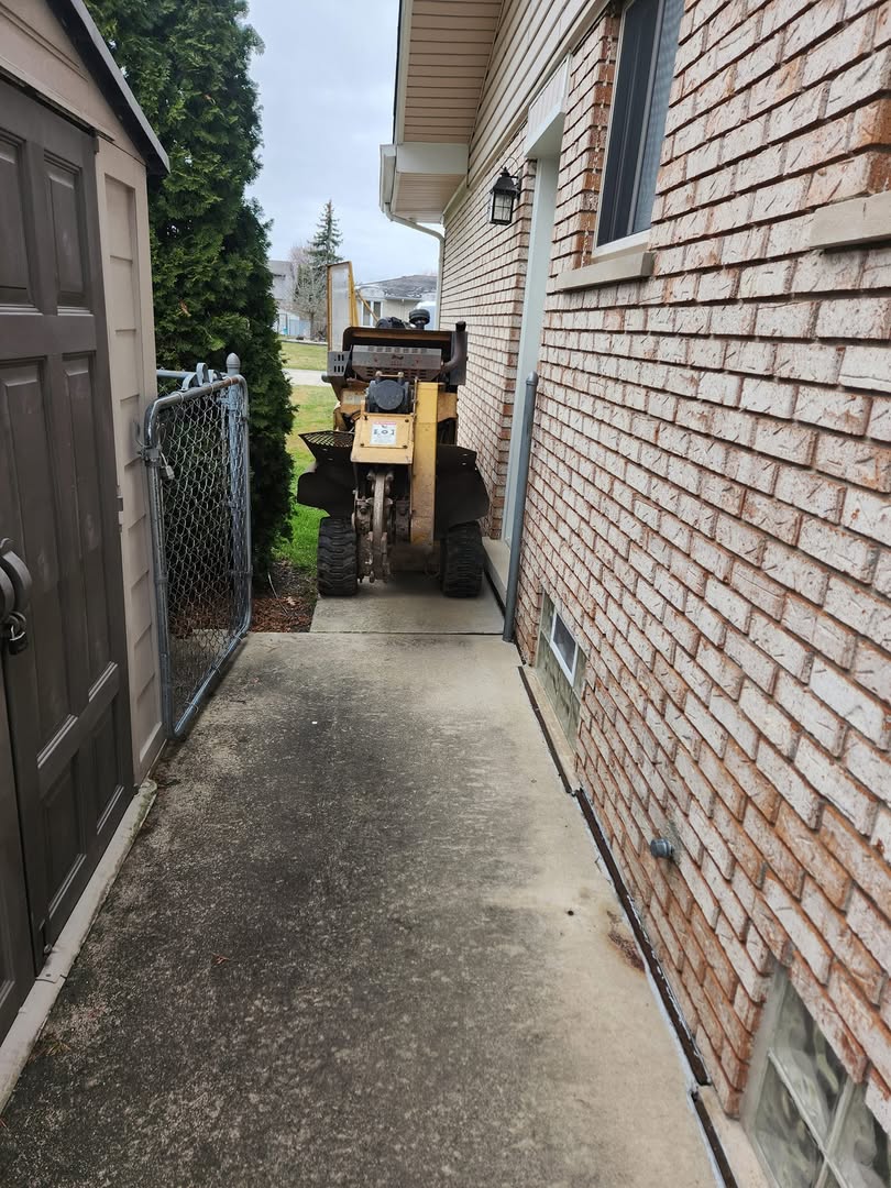 Compact stump grinder fits through tight backyard access in Clinton Township